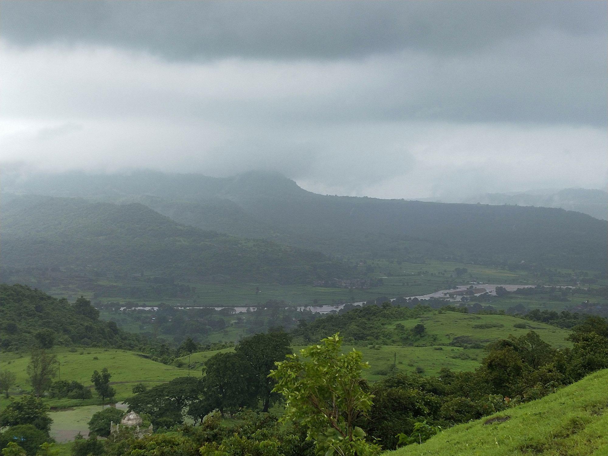 Monsoon clouds over the Western Ghats and green valley land at Pen, Raigad.